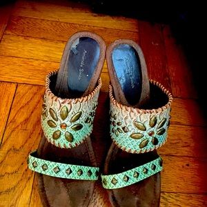 Platform high heeled sandals with teal and green colors and metal studs